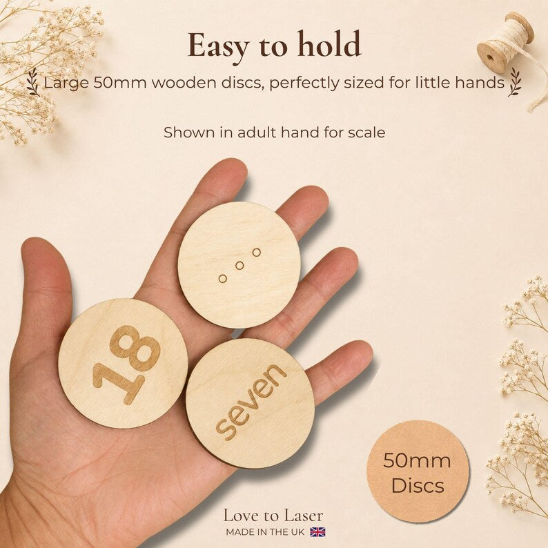 50mm wooden number matching discs shown in an adult hand for scale