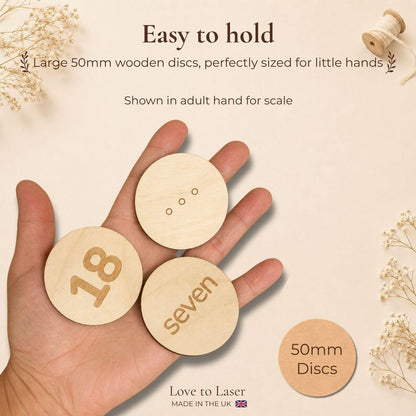 50mm wooden number matching discs shown in an adult hand for scale